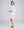 Back View: White Midi Beach Shirt with Perforated Cut Out Design
