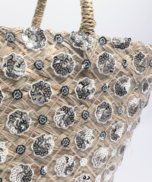 Close up View: Metallic Flower Embellished Straw Basket Bag with Secure Closure